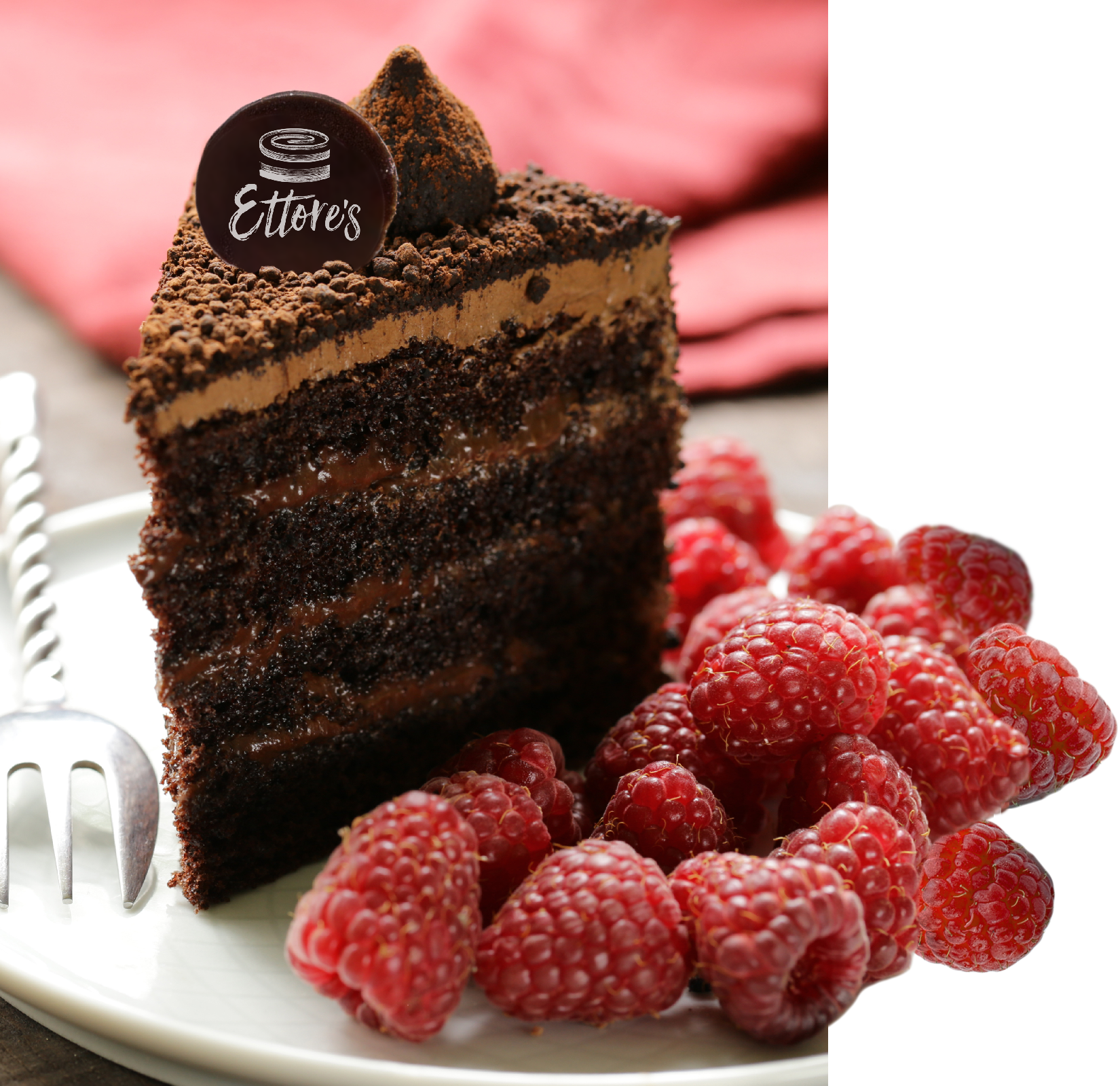 A piece of cake with a chocolate disc on top, showing the new Ettore's logo by Vs.